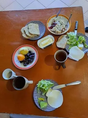 a wooden table with plates of food on it at Sea View House in Ribeira Brava