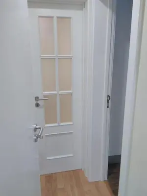 a white door with a window in a room at casa da fajã in Funchal