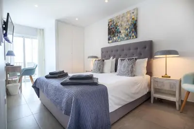a kitchen and dining room with a table and chairs at Waterside 3 Bedroom Sea view in Luz