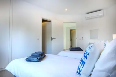 a bedroom with a bed and a table and a desk at Waterside 3 Bedroom Sea view in Luz