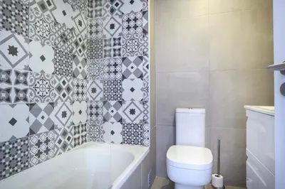 a bedroom with a large bed with a large headboard at Waterside 3 Bedroom Sea view in Luz