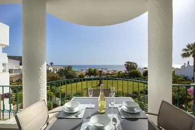 a white room with two beds and a window at Waterside 3 Bedroom Sea view in Luz