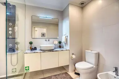 a bathroom with a sink and a toilet and a shower at Pérola - Madeira Inn Group in Funchal