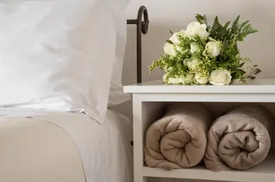 a bed with towels on a nightstand next to a bed at Casas de Campo do Pomar B&B - Self Check-in in Santana