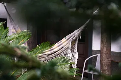 a hammock in front of a house at Casas de Campo do Pomar B&B - Self Check-in in Santana