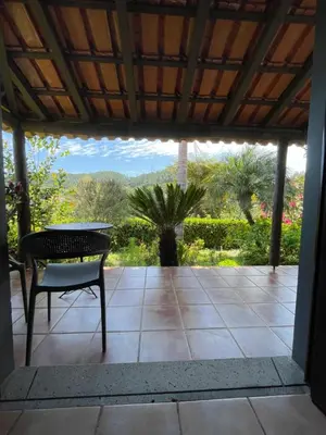 a patio with a table and a chair on a patio at Casas de Campo do Pomar B&B - Self Check-in in Santana