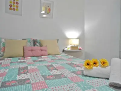 a bedroom with a bed with two sunflowers on it at Funchal Apartment in Funchal
