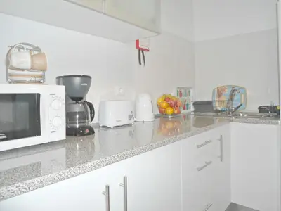 a kitchen with a microwave and a counter top at Funchal Apartment in Funchal