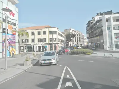a car parked in a parking lot on a city street at Funchal Apartment in Funchal