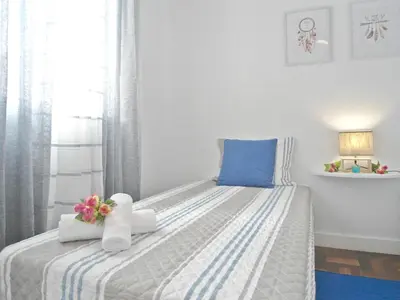 a bedroom with a bed with towels and flowers on it at Funchal Apartment in Funchal