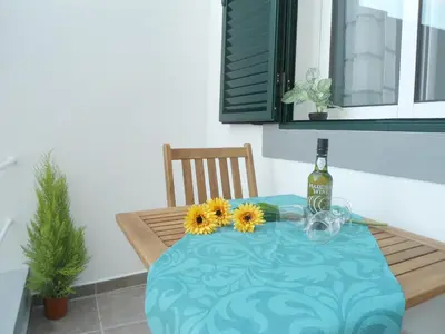 a table with a bottle of wine and sunflowers on it at Funchal Apartment in Funchal