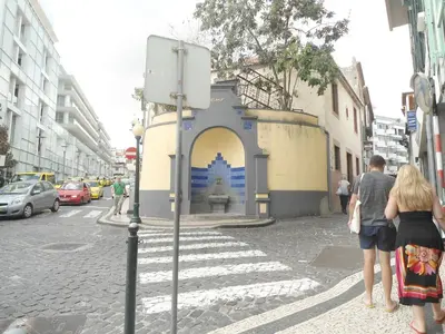 a group of people standing on a street at Funchal Apartment in Funchal