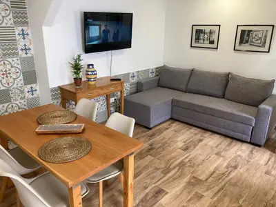 a living room with a couch and a table at Casa do Atlântico in Funchal