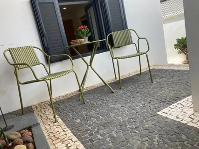 two chairs and a table on a patio at Casa do Atlântico in Funchal