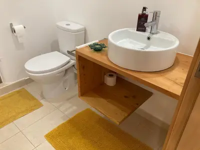 a bathroom with a sink and a toilet at Casa do Atlântico in Funchal