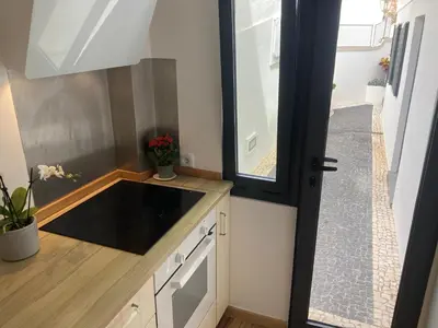 a small kitchen with a sink and a window at Casa do Atlântico in Funchal