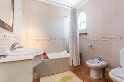 a bathroom with a sink and a toilet and a bath tub at Villa Paraiso da Luz by Seewest in Luz