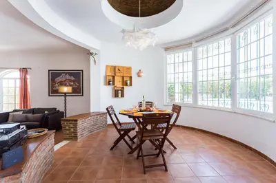 a living room with a table and chairs at Villa Paraiso da Luz by Seewest in Luz