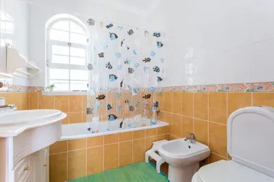 a bathroom with a sink and a toilet and a tub at Villa Paraiso da Luz by Seewest in Luz