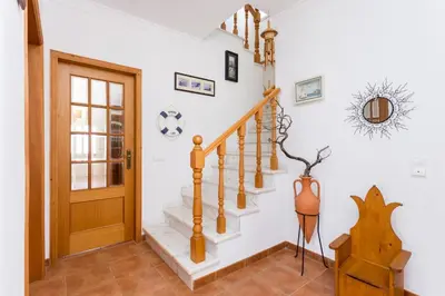 a staircase in a home with a wooden door at Villa Paraiso da Luz by Seewest in Luz
