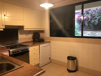 a kitchen with a stove and a sink and a window at Varandas do Funchal in Funchal
