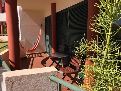 two chairs and a hammock on a house balcony at Varandas do Funchal in Funchal