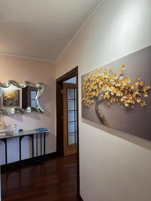 a bathroom with a painting of a tree on the wall at Varandas do Funchal in Funchal