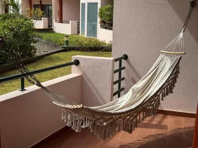 a hammock hanging on the side of a house at Varandas do Funchal in Funchal