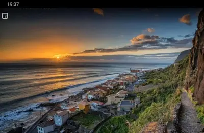 a view of the beach at sunset at Casa das bonecas 2 # Private Garage Included # in Paul do Mar