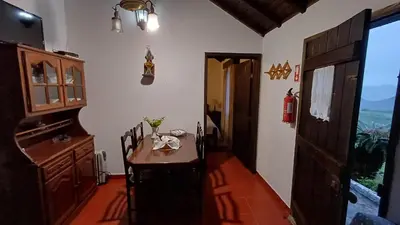 a room with a table and chairs and a door at Quinta do Monte Santo in Vila do Porto