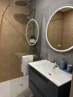 a bathroom with a sink and a mirror at Apartamentos Sol da Luz in Luz