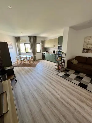 a large living room with a couch and a kitchen at Apartamentos Sol da Luz in Luz