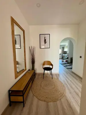 a living room with a bench and a mirror at Apartamentos Sol da Luz in Luz