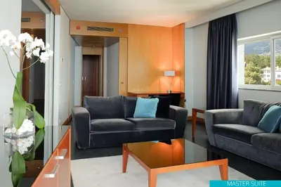 a living room with two couches and a table at VidaMar Resort Hotel Madeira in Funchal