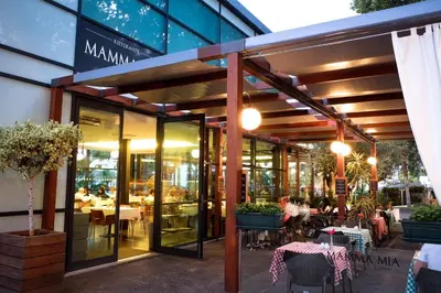 a restaurant with tables and chairs in front of a building at VidaMar Resort Hotel Madeira in Funchal