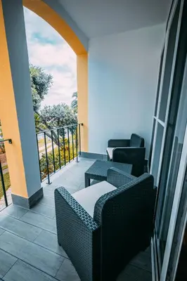a room with two chairs and a balcony with a view at Sea Breeze I in Caniço