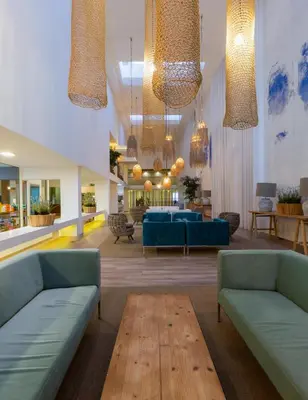 a lobby with blue furniture and chandeliers at The Views Oasis in Caniço