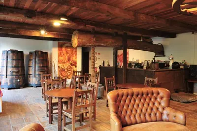 a dining room with tables and chairs and a couch at Estalagem do Vale in São Vicente