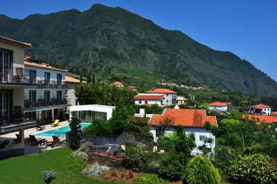 a view of a resort with a mountain in the background at Estalagem do Vale in São Vicente