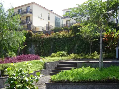 a garden with stairs in front of a building at Estalagem do Vale in São Vicente