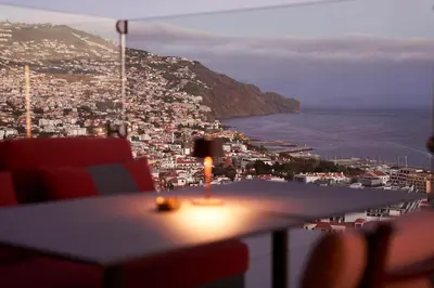 a bedroom with a large white bed in a room at The Views Baia - Adults Only in Funchal