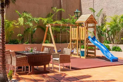 a playground with a table and chairs and a slide at Florasol Residence Hotel - Dorisol hotels in Funchal