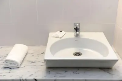 a white sink in a bathroom with a towel at Dorisol Estrelicia Hotel in Funchal