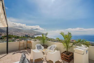 a balcony with a table and chairs and the ocean at Dorisol Mimosa Studio Hotel in Funchal