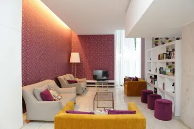 a living room with a couch and a tv at Dorisol Mimosa Studio Hotel in Funchal