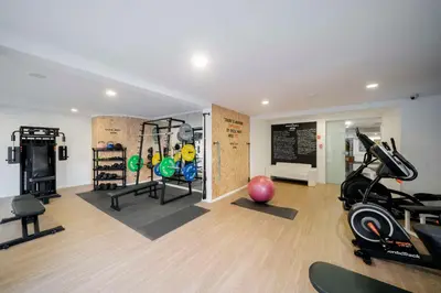 a gym with treadmills and exercise equipment in a room at Dorisol Mimosa Studio Hotel in Funchal