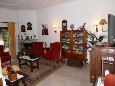 a living room with red chairs and a fireplace at Solar de Mos in Lagos
