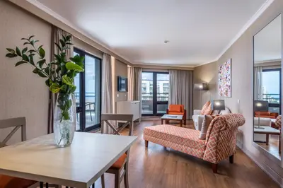 a living room with a vase of flowers on a table at Enotel Lido - All Inclusive in Funchal