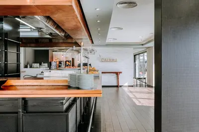 a kitchen with a counter with plates on it at Enotel Lido - All Inclusive in Funchal