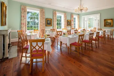 a dining room with tables and chairs and a chandelier at Quinta Jardins do Lago in Funchal